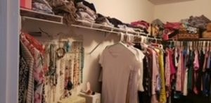 Closet before – crowded hanging clothes